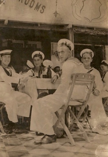 Gilbert (front) with crew mates sharing a beer 